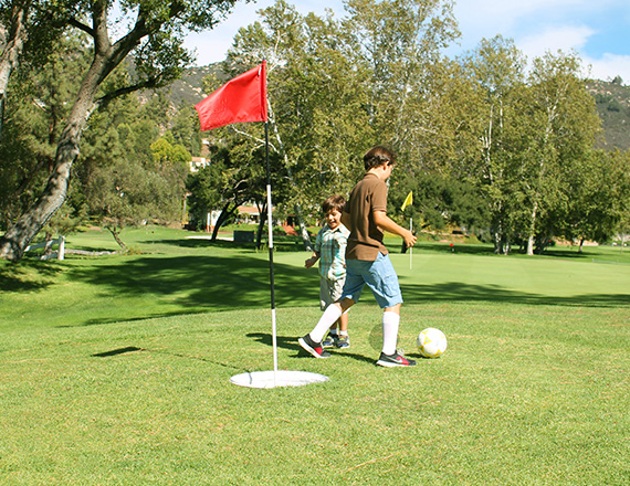 two boys playing footgolf