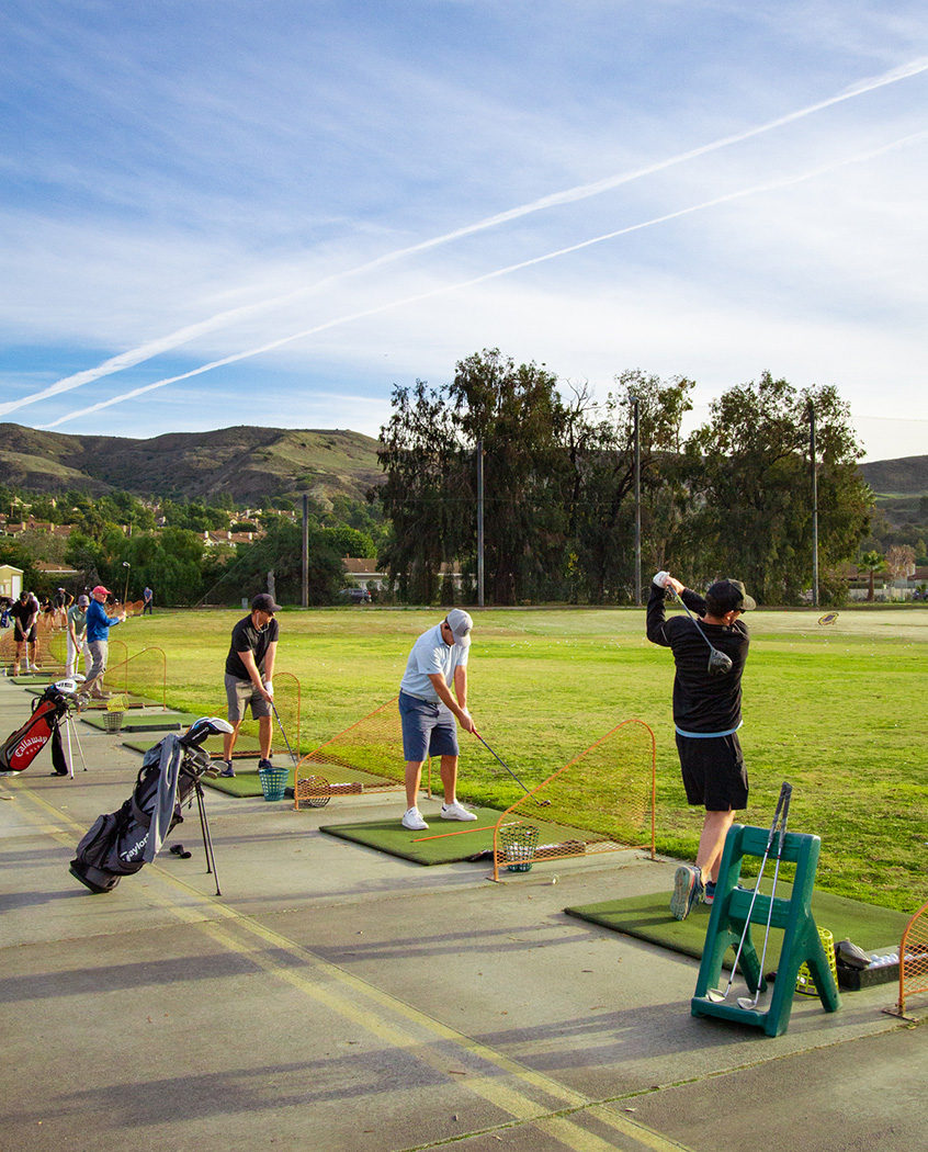 golfers on the driving range during the day