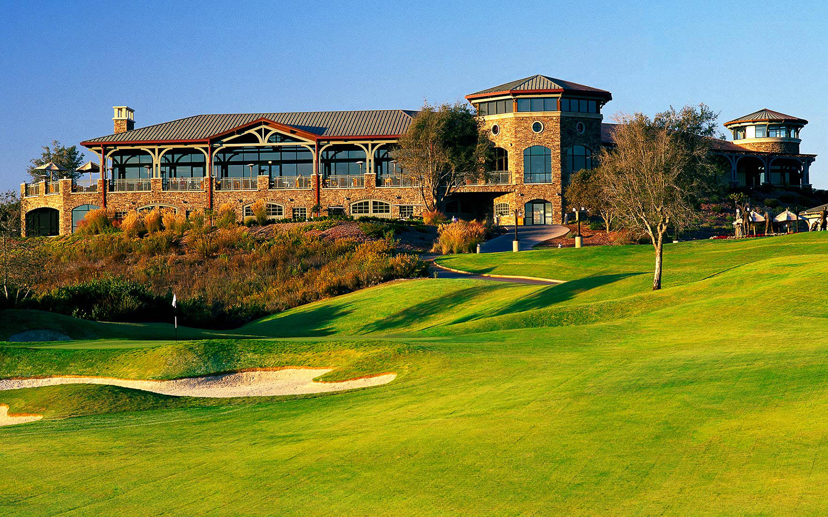 the main building overlooking the golf course during the day