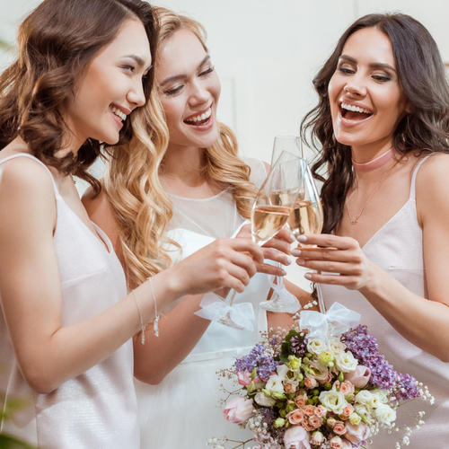 Three bridesmaids toasting with glasses if champaign