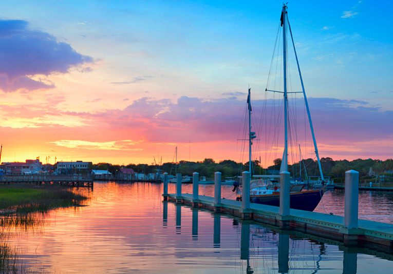Intercostal during sunset with boats docked on marina