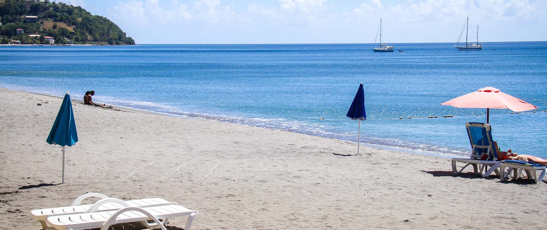view of beach and chairs with umbrellas