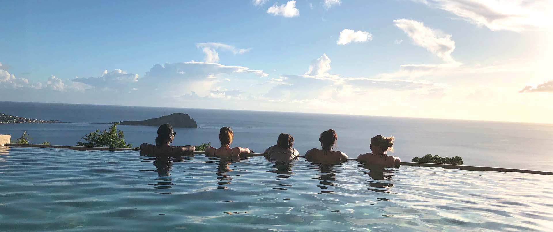 5 people at the edge of an infinity pool