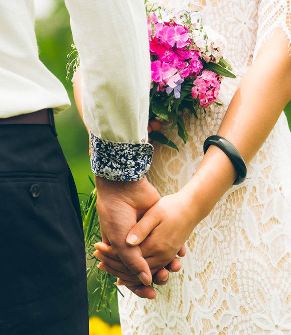up-close couple holding hands