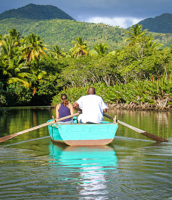 man rowing a small boat with woman aboard