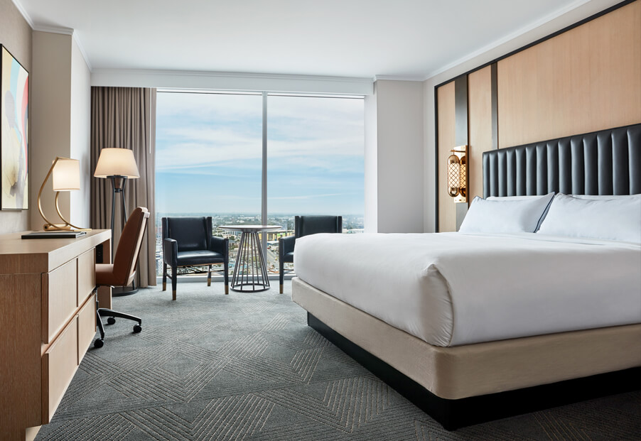 white bed in room with city view