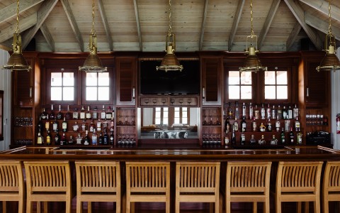 a restaurant bar with selection of alcohol bottles on shelves 
