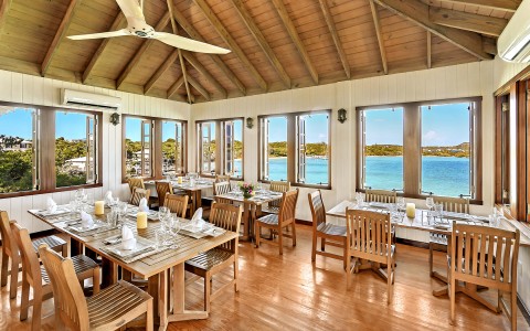 internal view of Beacon restaurant with a ceiling fan, several windows around and ocean view    