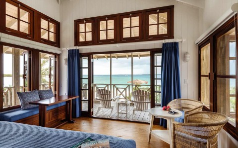 Internal view of a room with private balcony and different types of chairs