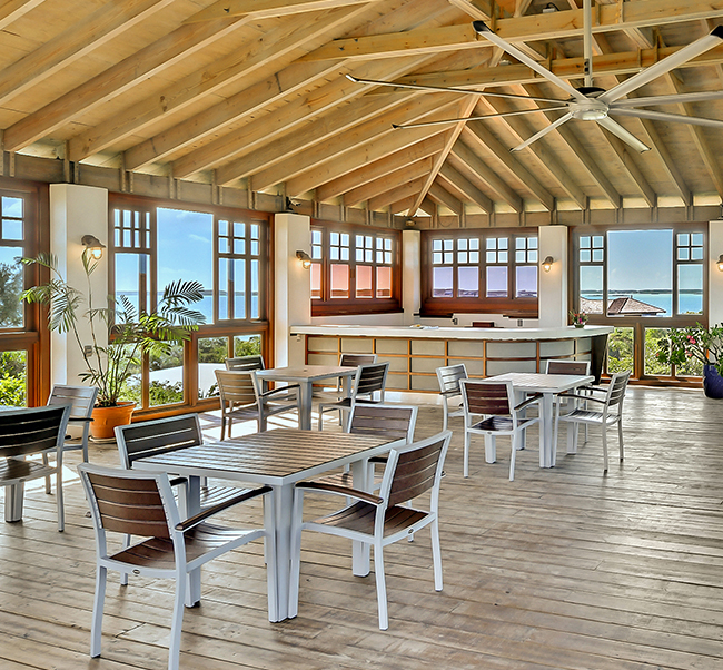 restaurant overlooking the ocean with wooden beams in the ceiling