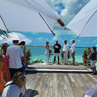 people getting married on a wooden deck