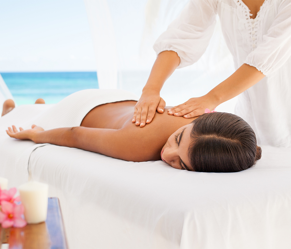 View of a woman getting a relaxing massage at the beach