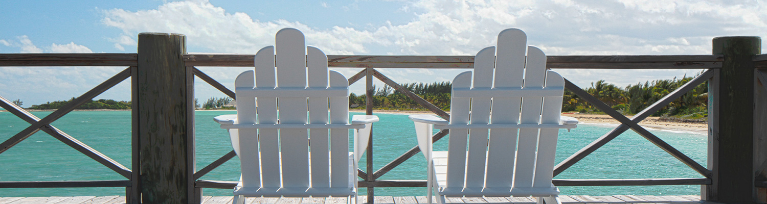two chairs on balcony overlooking sea