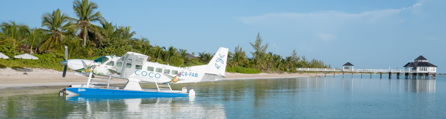 Header Sea Plane landing on a tropical island
