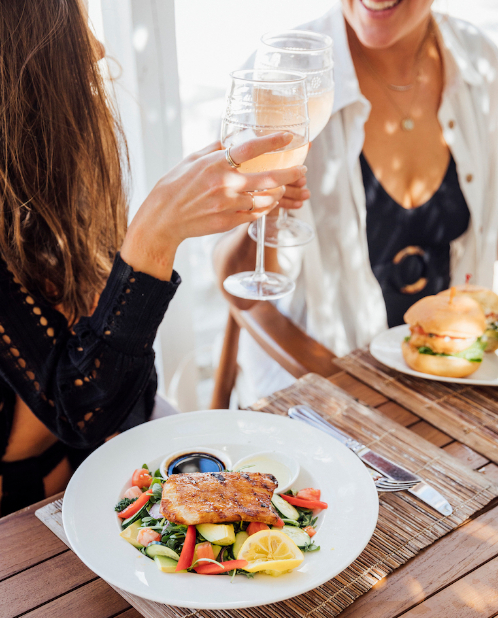 women enjoying wine and seafood