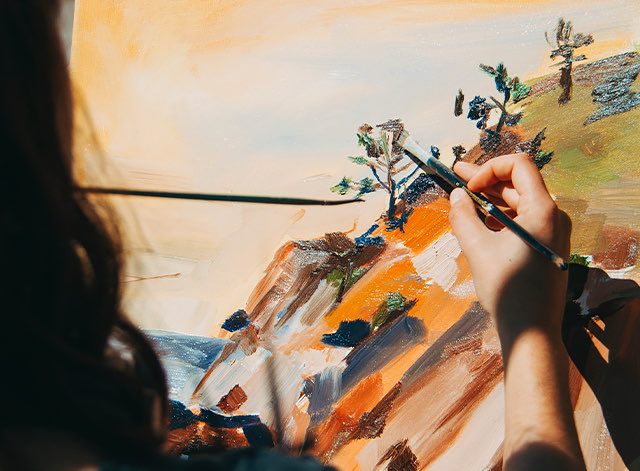 A person painting on a canvas