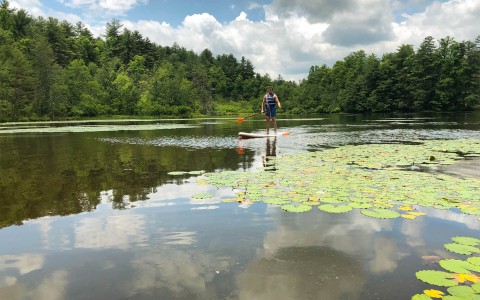 landscape view and a guy enjoying the lake