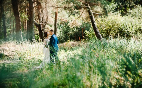 bride and groom kissing and hugging  in the nature