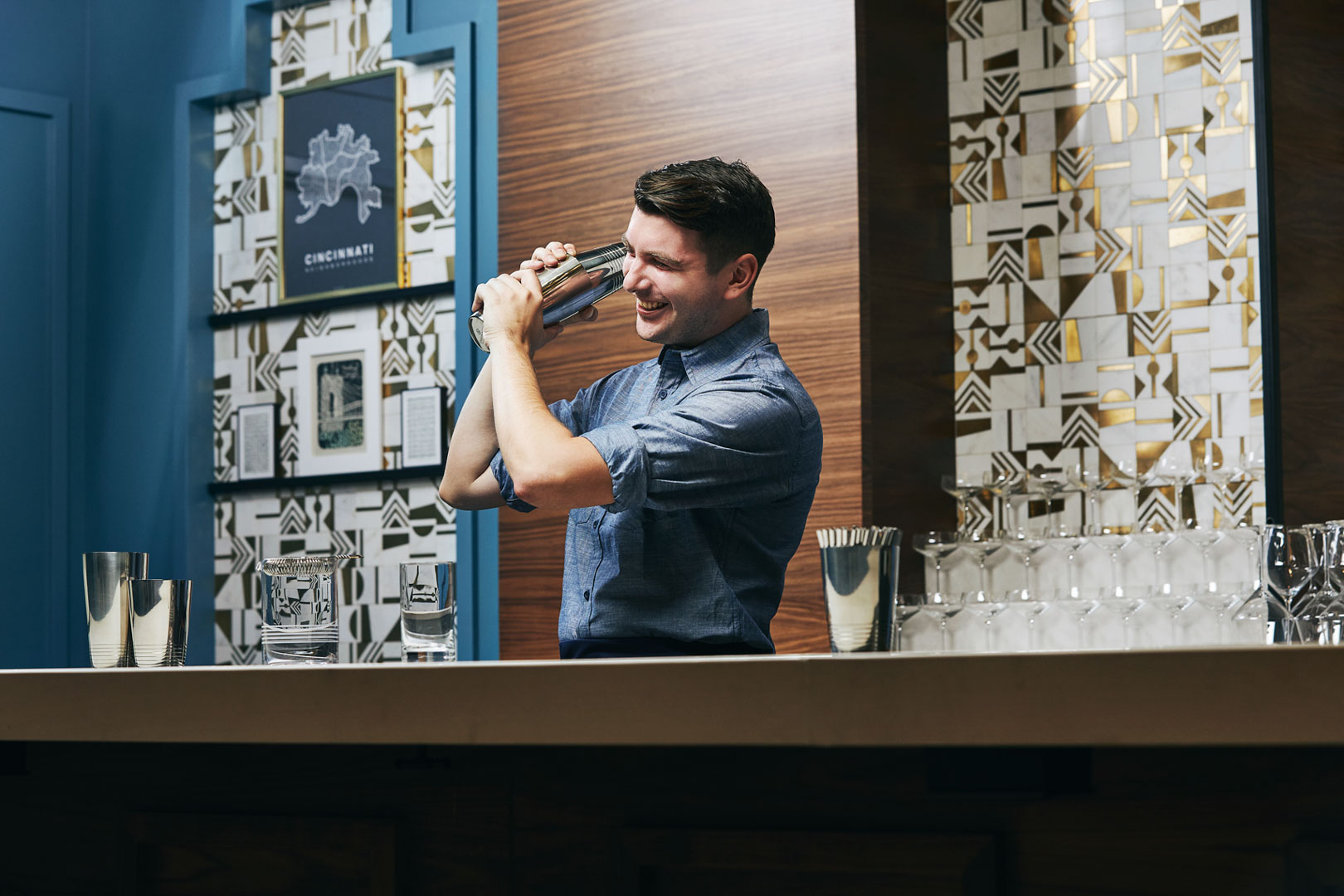 bartender shaking a cocktail behind the bar