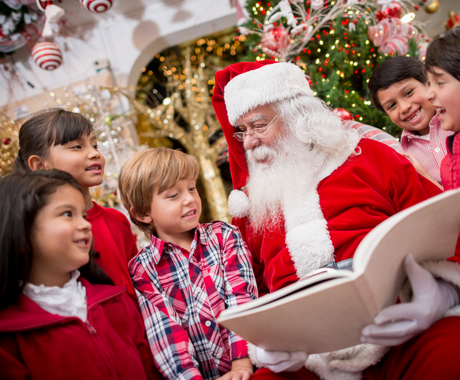 santa claus reading to a group of kids