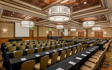 big meeting space with rows of tables and chairs