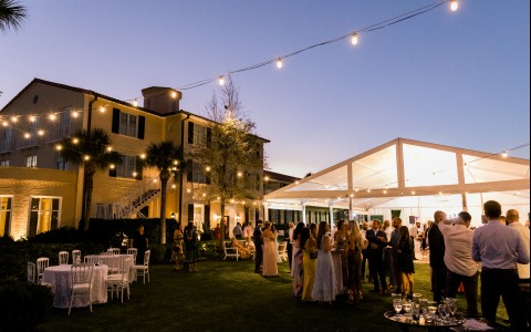 outdoor wedding venue with twinkly lights and white tent