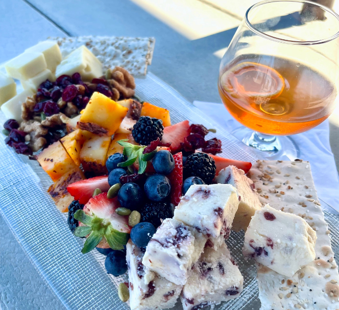 view of charcuterie board with a cocktail