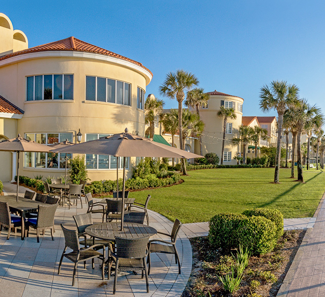 view of resort property outdoor dining area and paved pathways and boardwalk