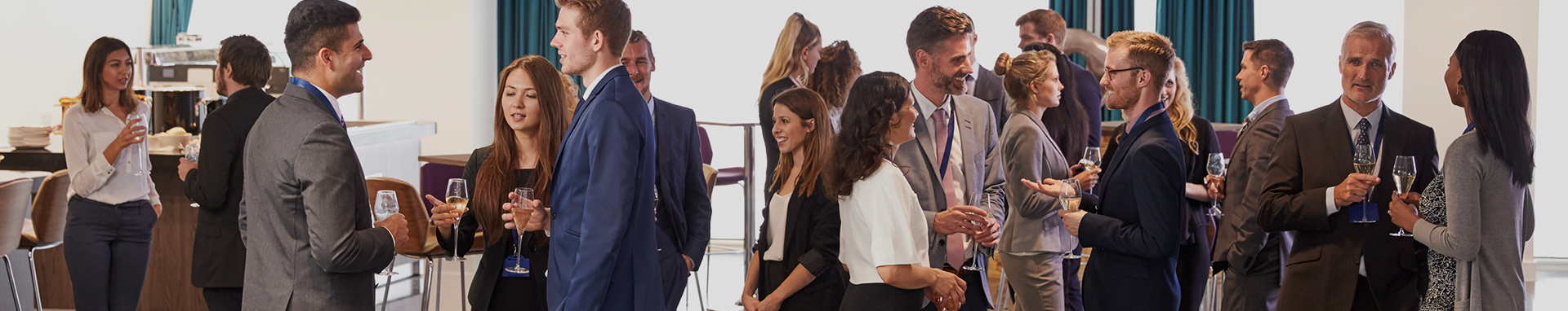 large group of business professionals networking with cocktails