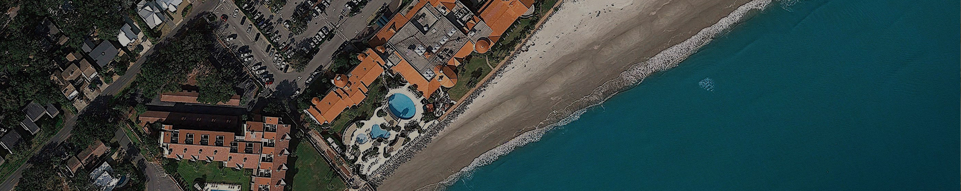aerial view of resort property with ocean shoreline coast