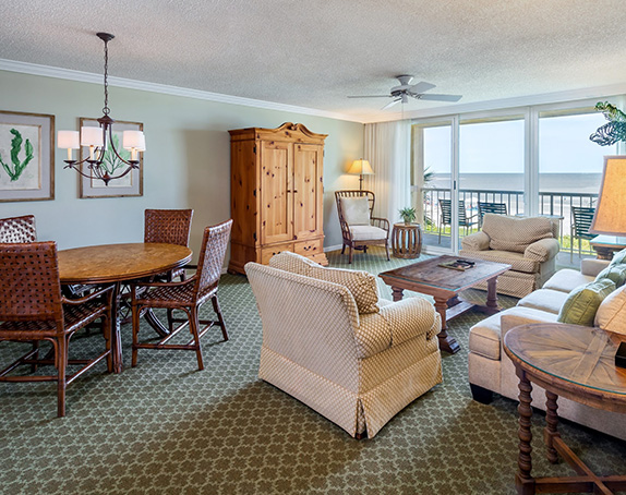 Beach Villa living room and dining area with large patio windows overlooking beach