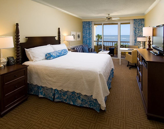 accommodation with king size bed and large patio doors leading to balcony