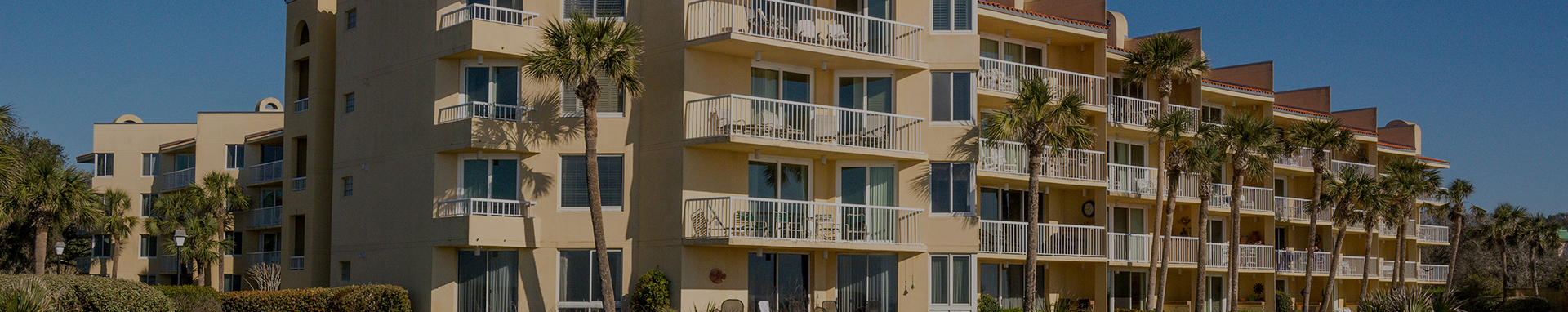 view of resort building featuring large patio door balconies on each floor
