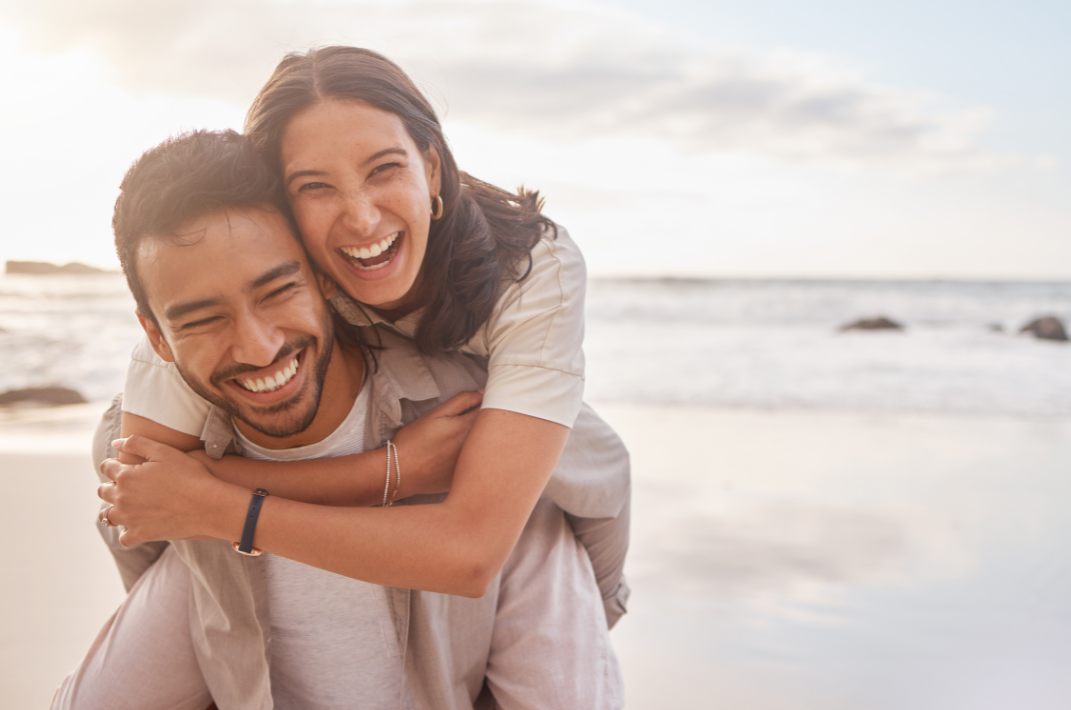 happy couple hugging on the beach