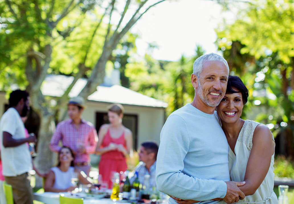 A happy mature couple posing for a picture outdoors
