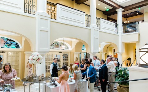various guests getting their food from the platters at a wedding
