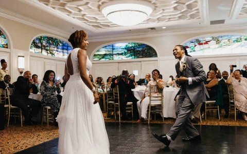 bride and groom dancing at the reception in front of their guests