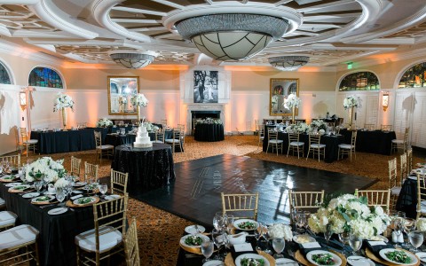 view of the delegal room with elegant place settings and white floral centerpieces