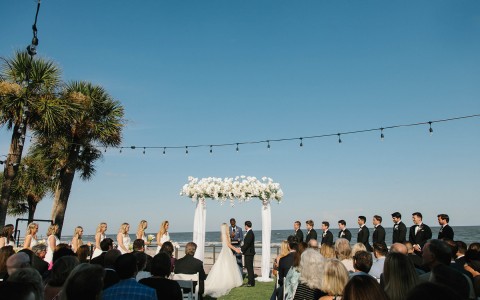 bride and groom at the altar with the ocean in the background