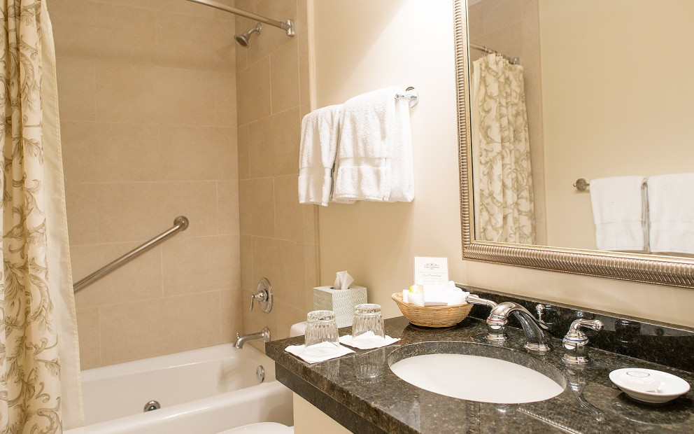 black granite bathroom vanity with cream shower curtain