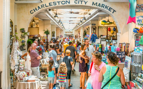 Crowd of people walking through Charleston City Market entrance