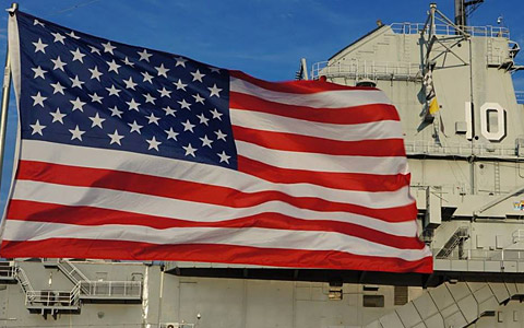 American flag waving in front of building