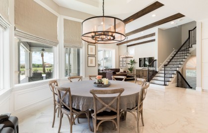 Small circle table with a stylish ceiling light and eight chairs 
