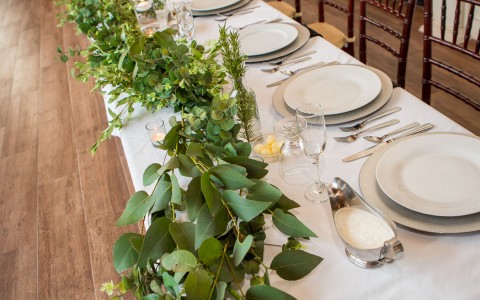 large table with all cutlery set up for a special occasion 