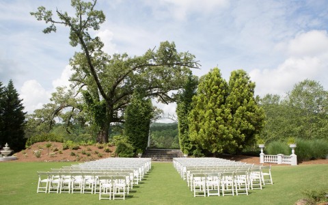 view of all decoration and furniture set up for a wedding in the nature at daytime