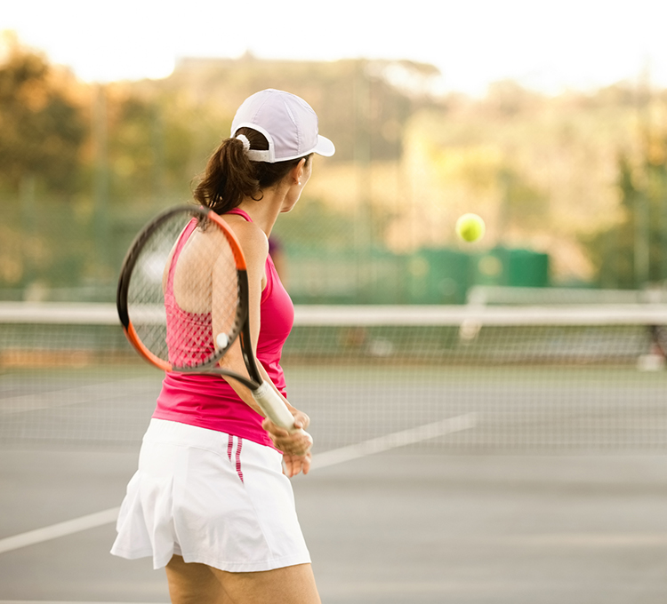 Woman playing tennis waiting for kick the ball 