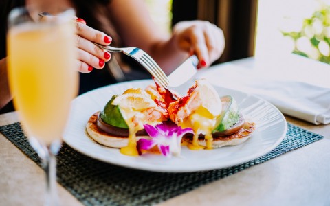 close up view of an elegant dish on a white plate served with a mimosa