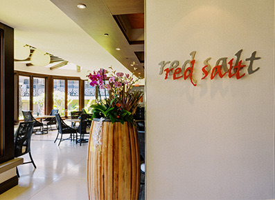 entrance to the red salt restaurant with a large wooden flower pot