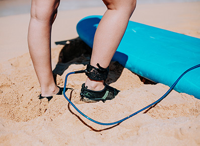 view of a person on the beach connected to a surfboard