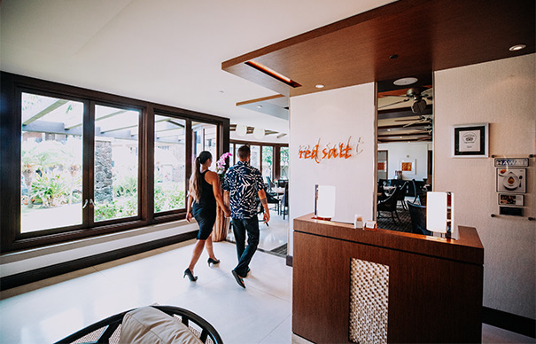 well dressed man and woman walking into the red salt restaurant